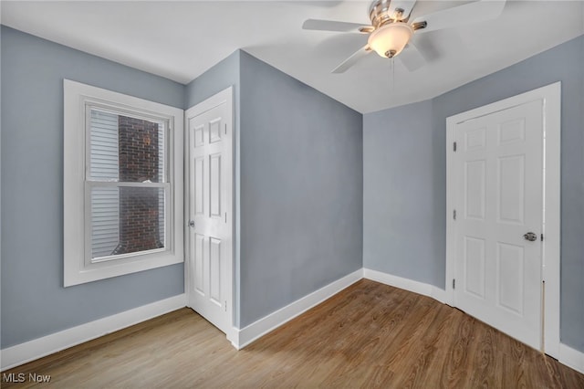 interior space with ceiling fan, light wood-type flooring, and a closet