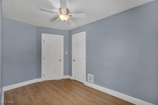 empty room featuring ceiling fan and light hardwood / wood-style flooring