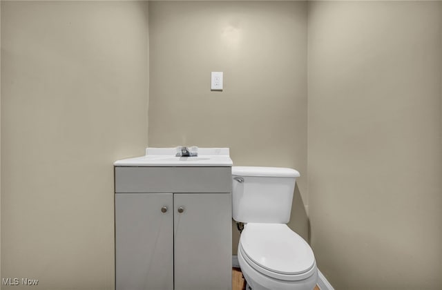 bathroom featuring toilet and vanity