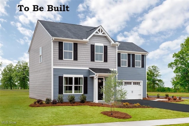 view of front facade featuring a front yard and a garage