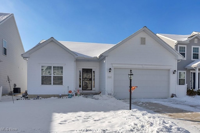 view of front of house with a garage and central AC unit