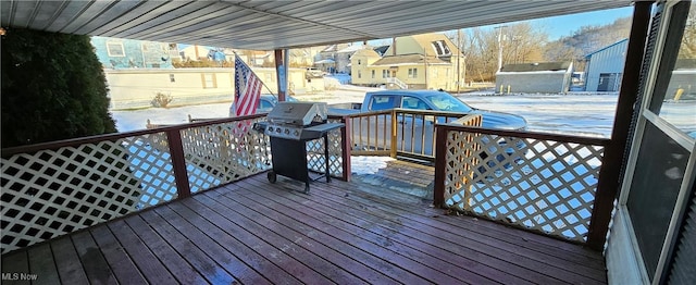 snow covered deck featuring area for grilling