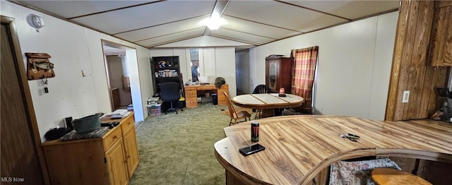 carpeted office featuring lofted ceiling