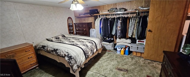 bedroom featuring ceiling fan and dark carpet