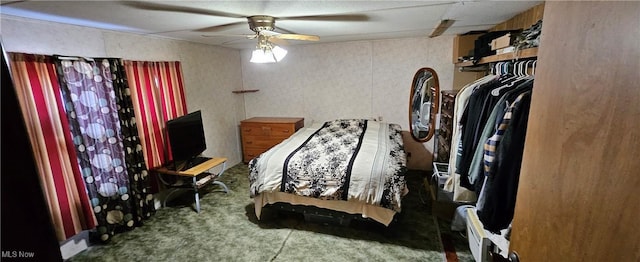 bedroom featuring ceiling fan, a closet, and carpet flooring