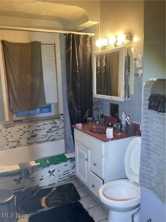 full bathroom with tile patterned floors, vanity, decorative backsplash, toilet, and shower / bath combo