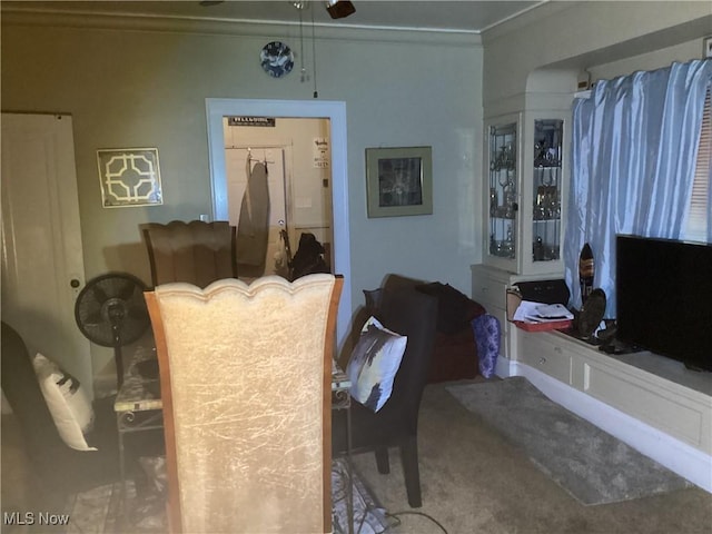 interior space featuring ceiling fan and crown molding