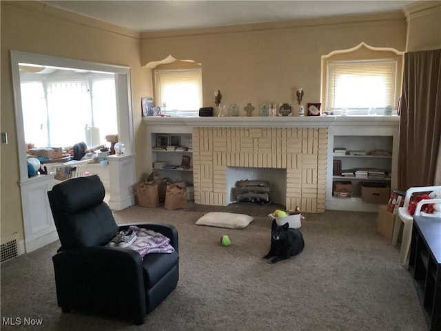 living room featuring a fireplace, plenty of natural light, crown molding, and carpet flooring