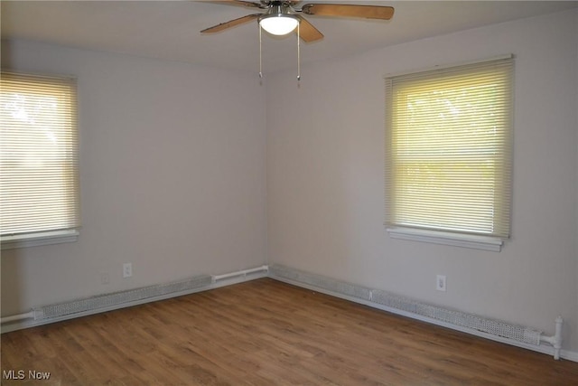 spare room featuring hardwood / wood-style flooring, plenty of natural light, and ceiling fan