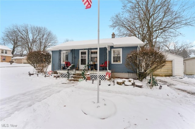 view of front of property with covered porch and a garage