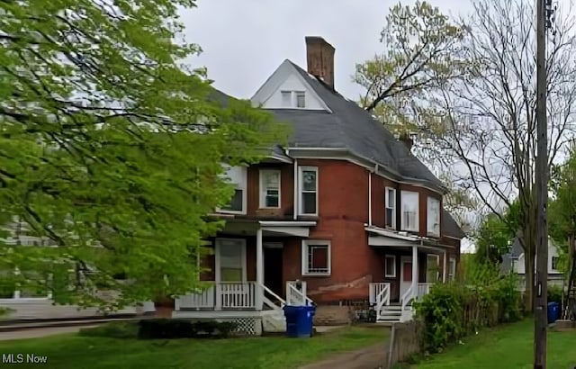 rear view of house featuring a yard