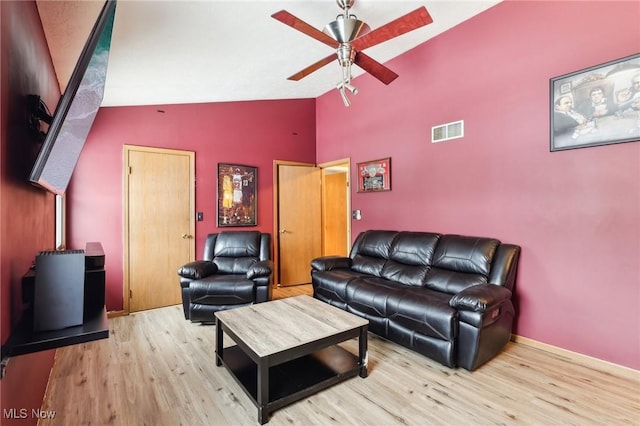 living room with light hardwood / wood-style floors, high vaulted ceiling, and ceiling fan