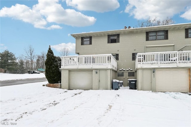 snow covered house featuring a balcony