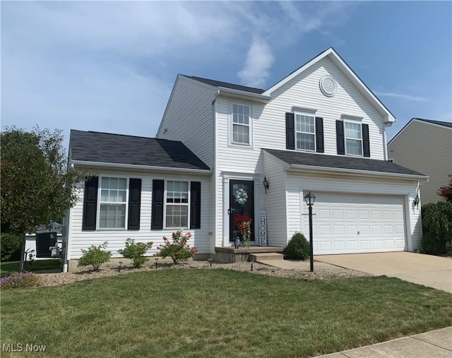 view of front of property with a garage and a front yard