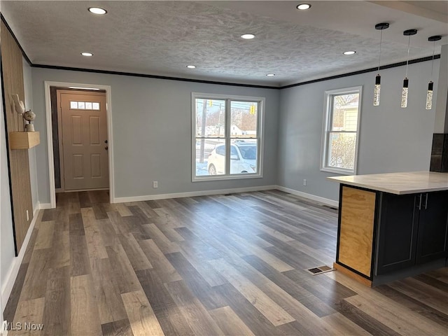 interior space featuring crown molding, plenty of natural light, and dark hardwood / wood-style floors