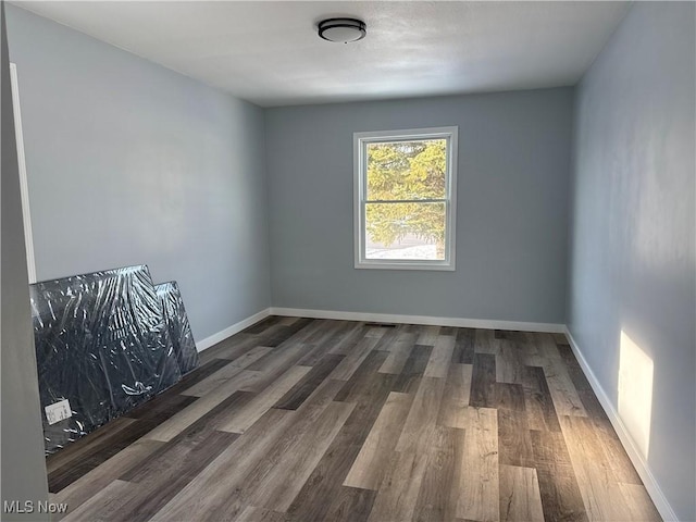 empty room with dark hardwood / wood-style floors