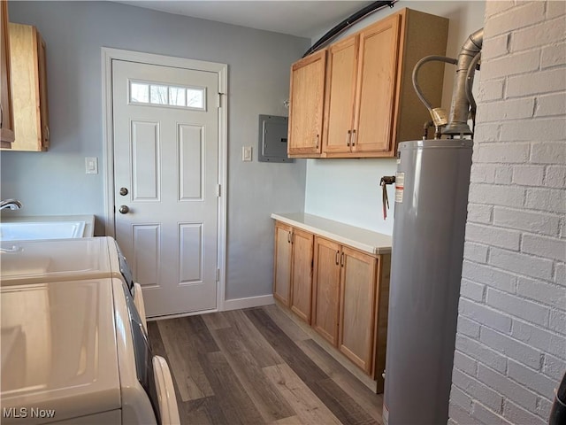 laundry room featuring washer and dryer, water heater, sink, cabinets, and electric panel