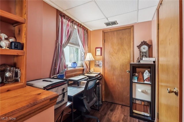 office space featuring dark hardwood / wood-style flooring and a drop ceiling