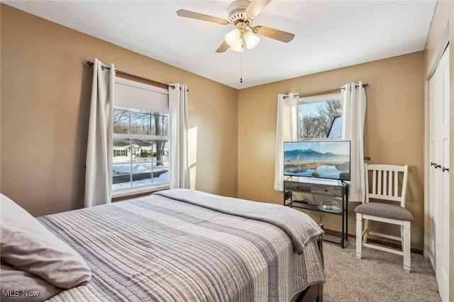 carpeted bedroom featuring ceiling fan