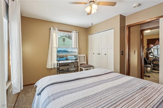 carpeted bedroom with ceiling fan and a closet