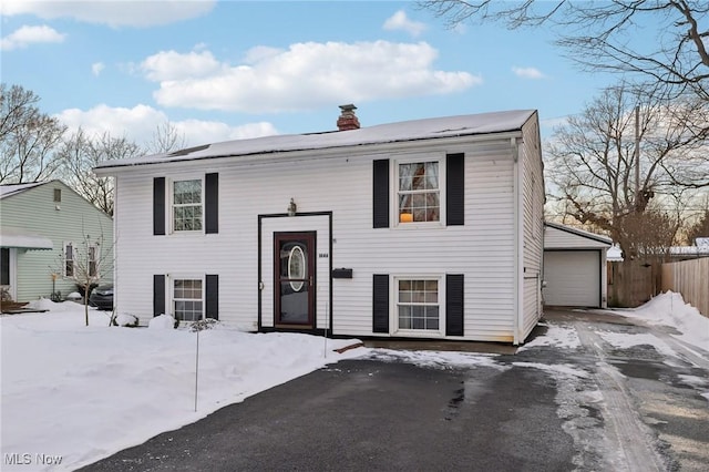 split foyer home featuring an outbuilding and a garage