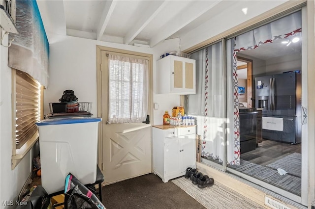 laundry area with dark colored carpet