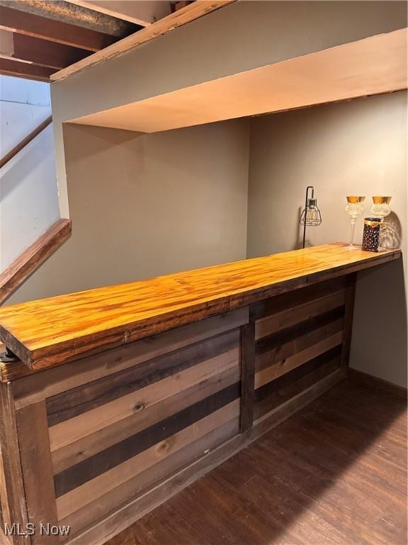 bar with dark hardwood / wood-style floors and butcher block counters