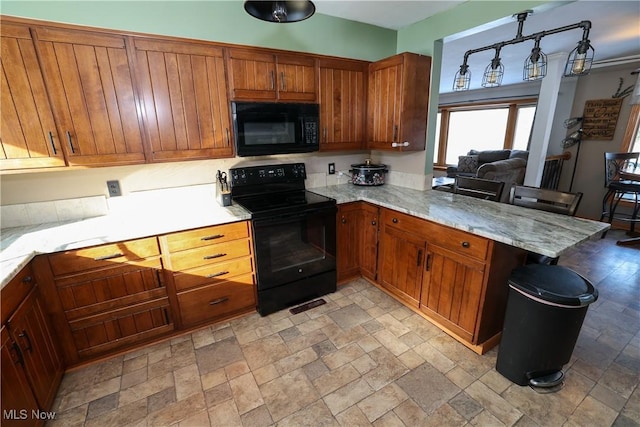 kitchen with black appliances and kitchen peninsula