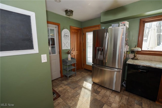 kitchen with dishwasher and stainless steel fridge