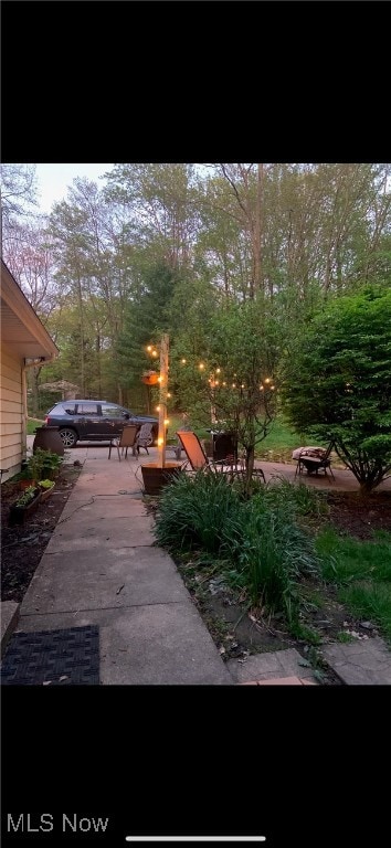 view of yard featuring a patio area and a fire pit