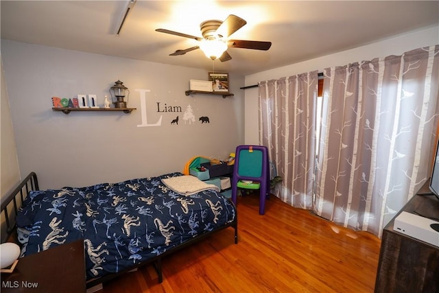 bedroom featuring ceiling fan and hardwood / wood-style floors