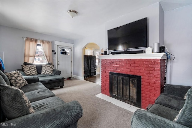 living room featuring light carpet and a fireplace