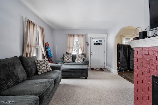 carpeted living room featuring a fireplace