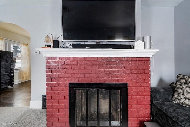 53 Shields Rd, Youngstown, OH 44512 - detailed view of a fireplace, arched walkways, carpet, baseboards, and wood finished floors