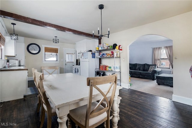 53 Shields Rd, Youngstown, OH 44512 - dining space with baseboards, arched walkways, dark wood finished floors, and beam ceiling