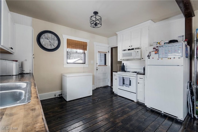 kitchen featuring dark hardwood / wood-style floors, decorative light fixtures, white appliances, white cabinets, and sink