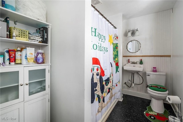 bathroom with toilet and a shower with curtain