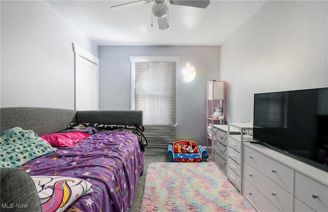 bedroom with ceiling fan and light carpet