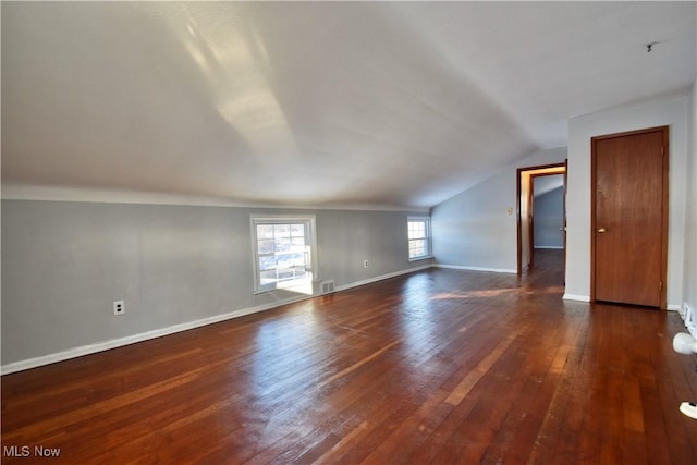 bonus room featuring vaulted ceiling and dark wood-type flooring