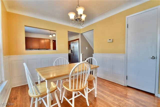 dining room featuring light hardwood / wood-style floors and a chandelier