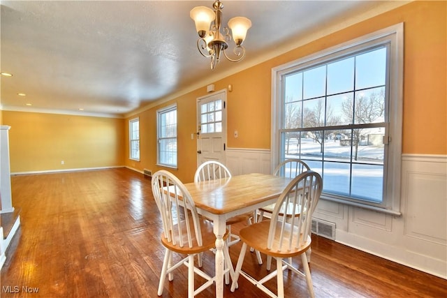 dining room featuring hardwood / wood-style floors and a chandelier