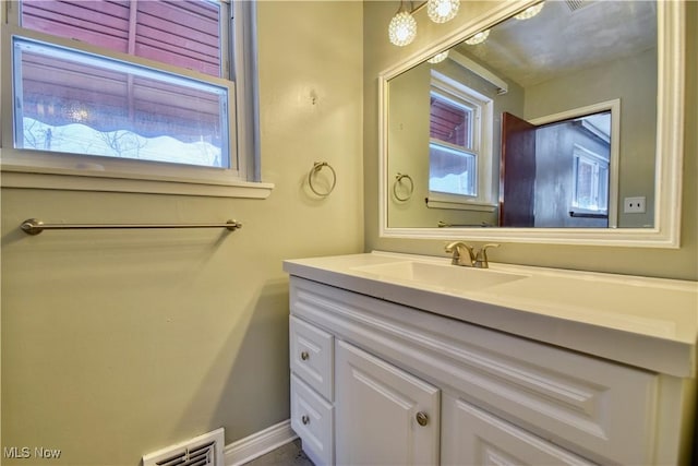 bathroom with plenty of natural light and vanity