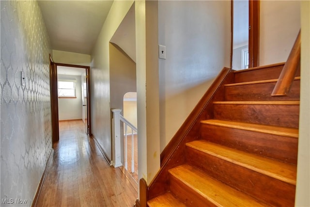 stairs featuring hardwood / wood-style floors