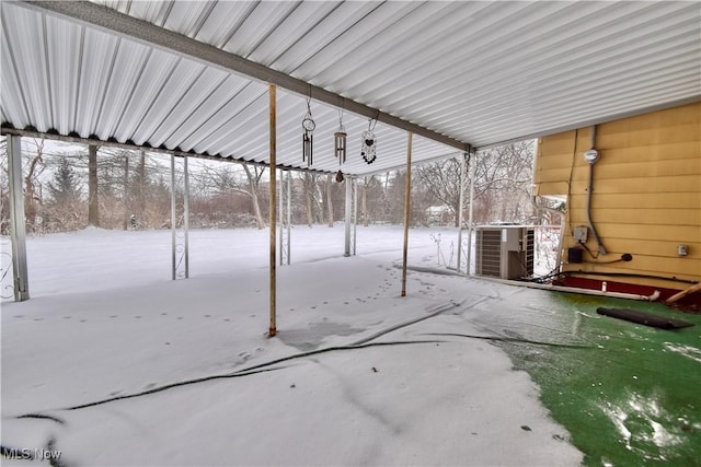 snow covered patio featuring cooling unit