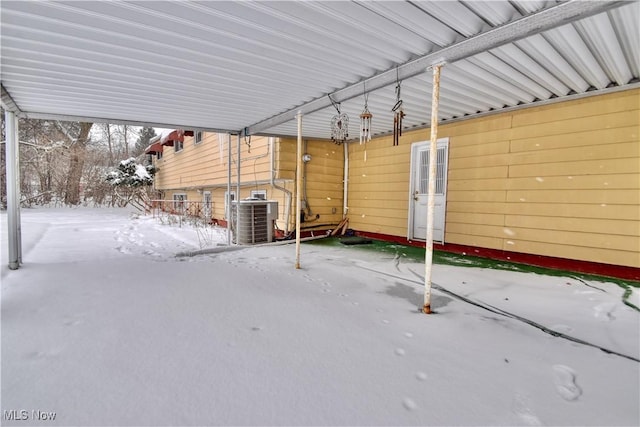 snow covered patio with central air condition unit