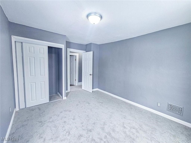 unfurnished bedroom featuring a closet and carpet flooring