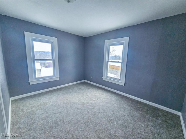 carpeted empty room with plenty of natural light