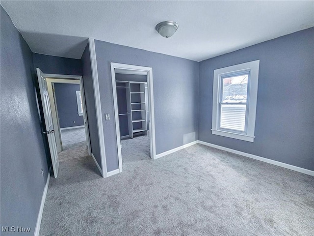 unfurnished bedroom featuring carpet and a closet