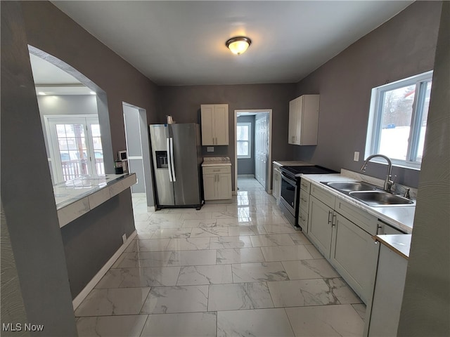 kitchen with plenty of natural light, sink, and stainless steel appliances