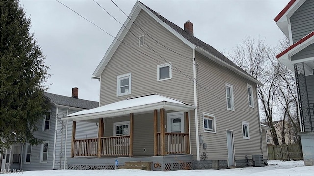 view of front of home with cooling unit and a porch